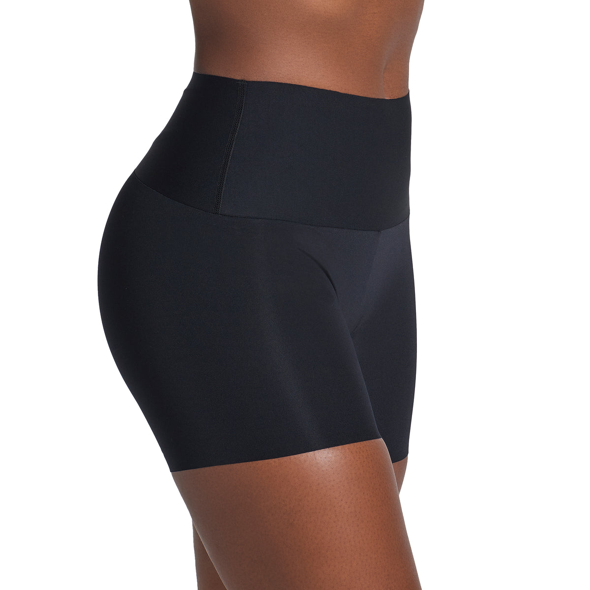 Black athletic shorts worn by a person on a white background