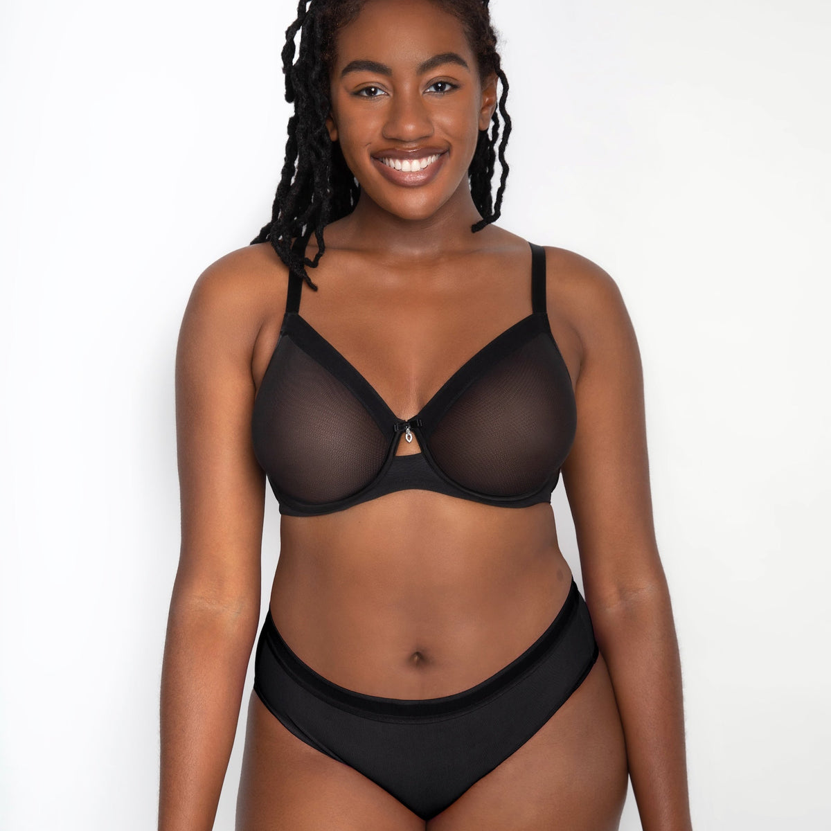 Woman wearing a black lingerie set on a white background