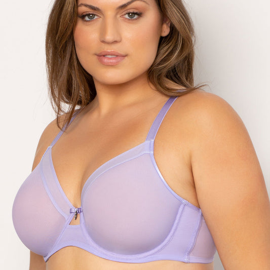 Woman wearing a light purple bra against a plain background
