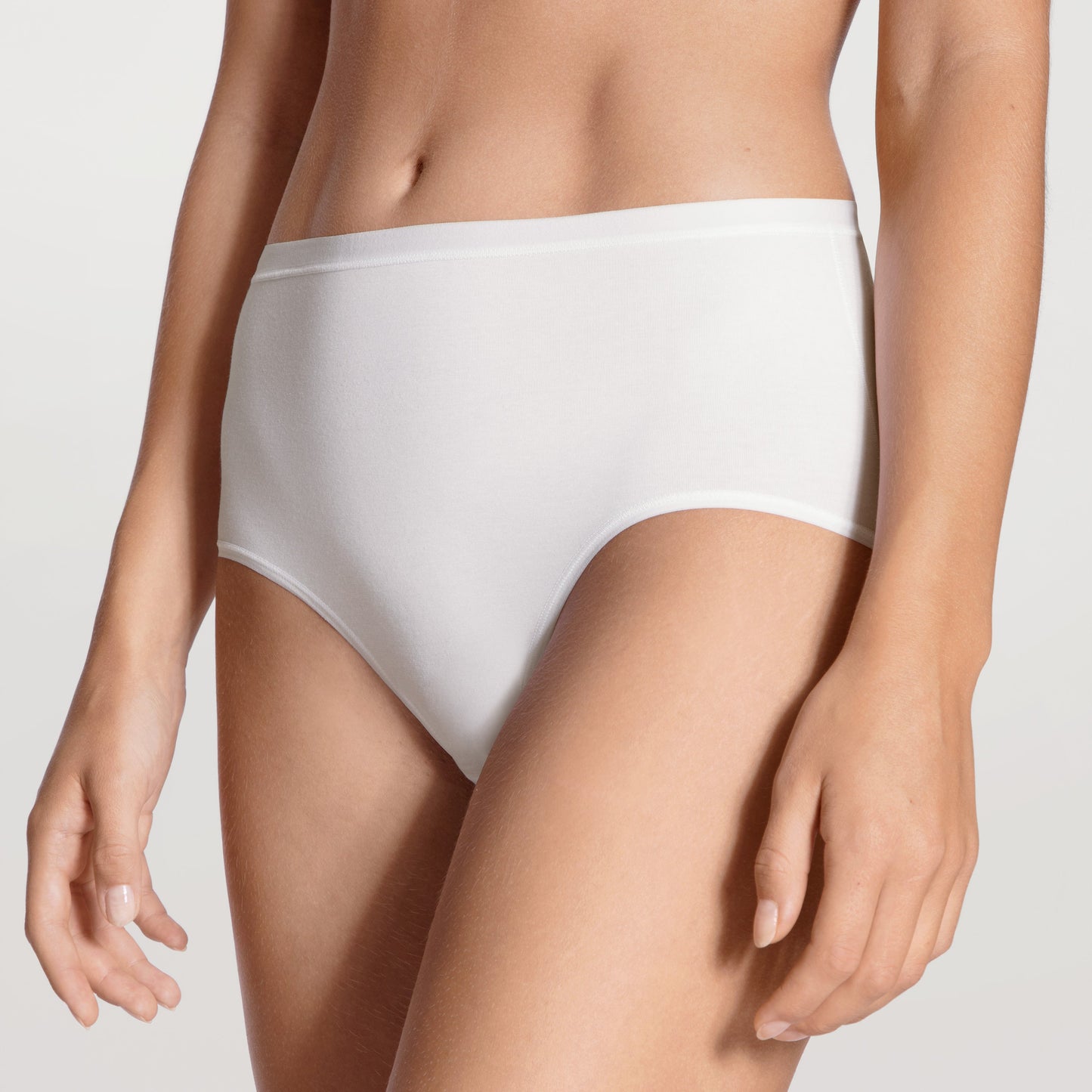 White underwear worn by a person on a plain background