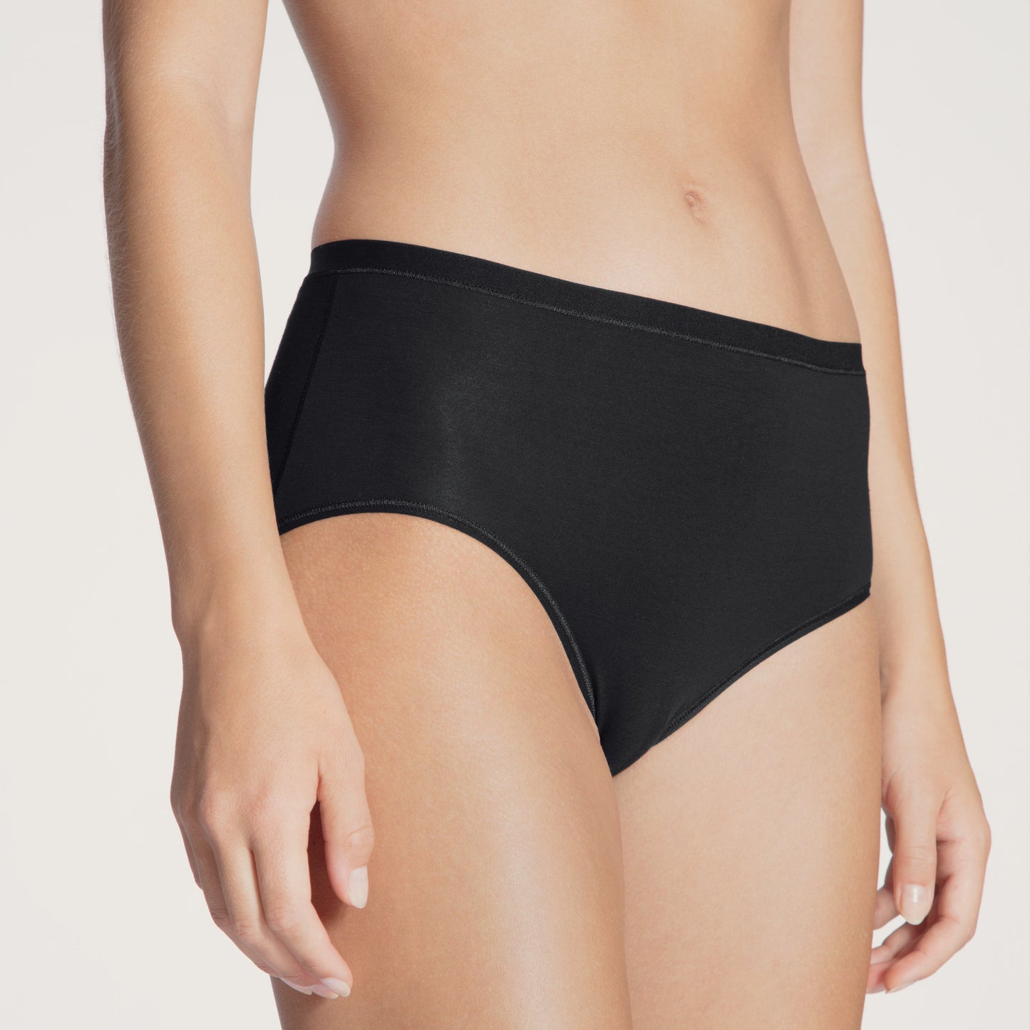 A high-waist black brief underwear on a model.