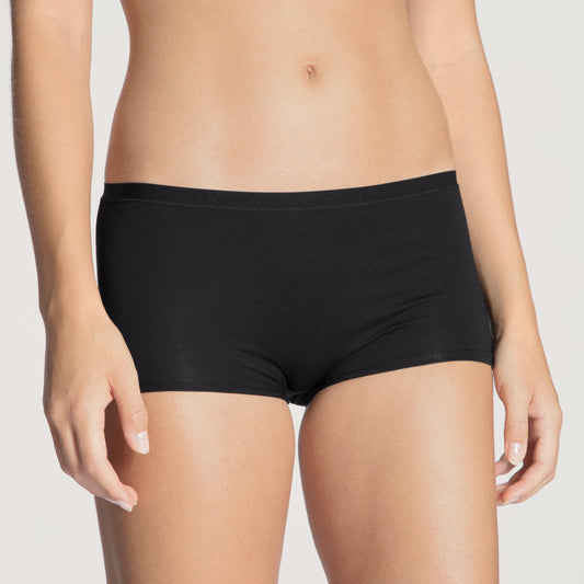 Black underwear worn by a person on a plain background