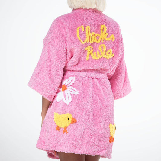 Pink robe with floral and duck designs, worn by a person on a white background