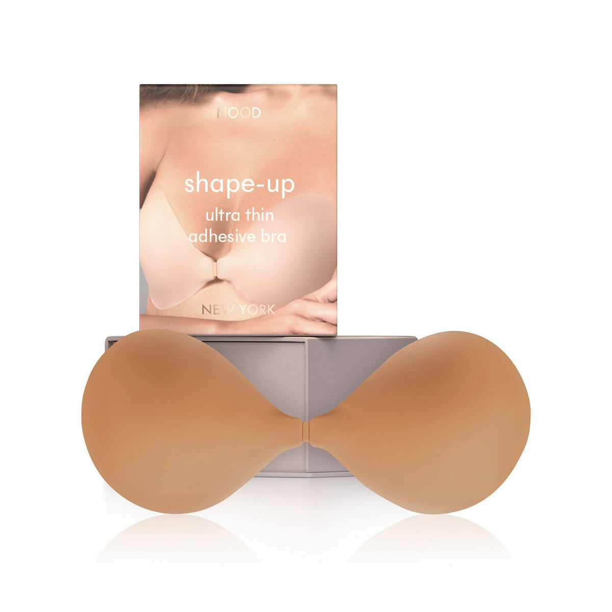 Brown adhesive bra on a white background with packaging labeled 'shape-up'.