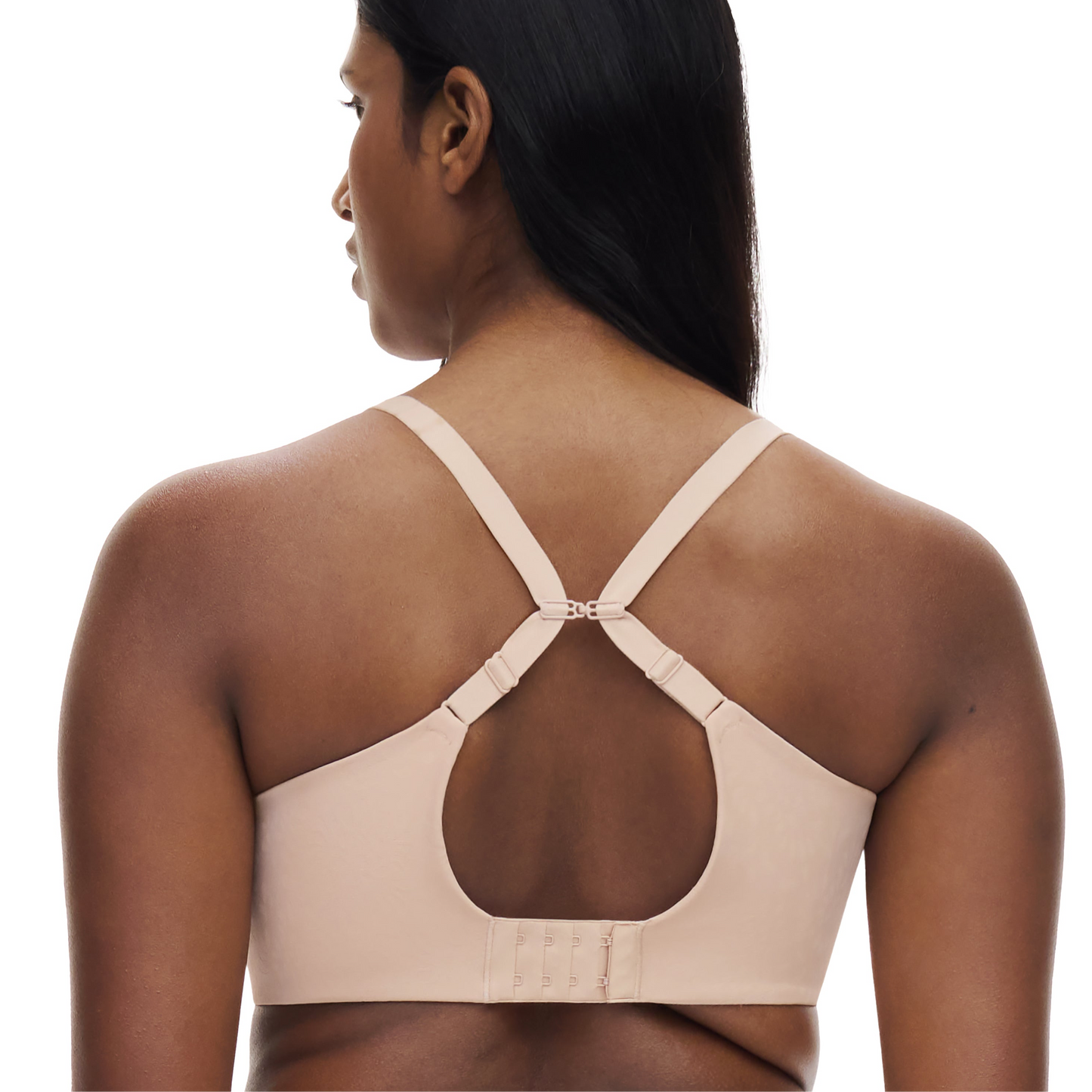 Beige sports bra worn by a model on a white background