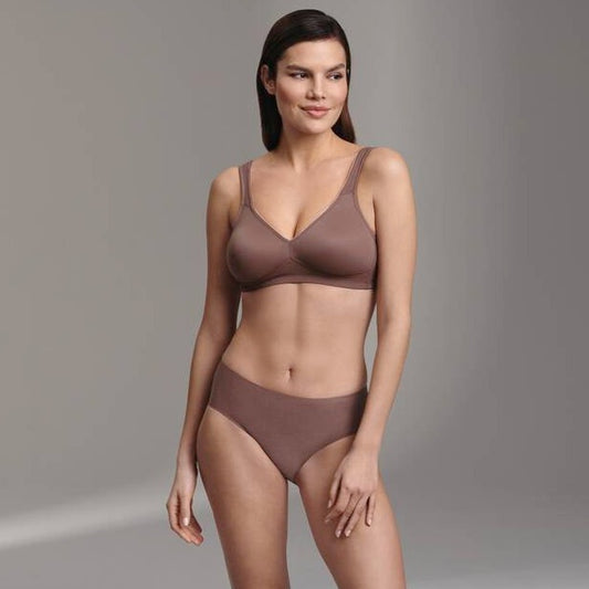 A woman wearing a twin wireless soft bra in berry color, with no wires, made of microfiber fabric.