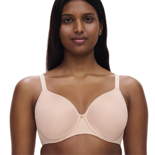 Woman wearing a beige bra on a white background