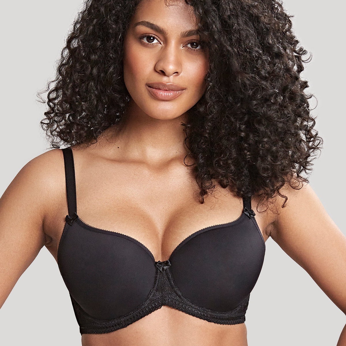 A woman wearing a black Spacer bra with Swiss designed embroidery.