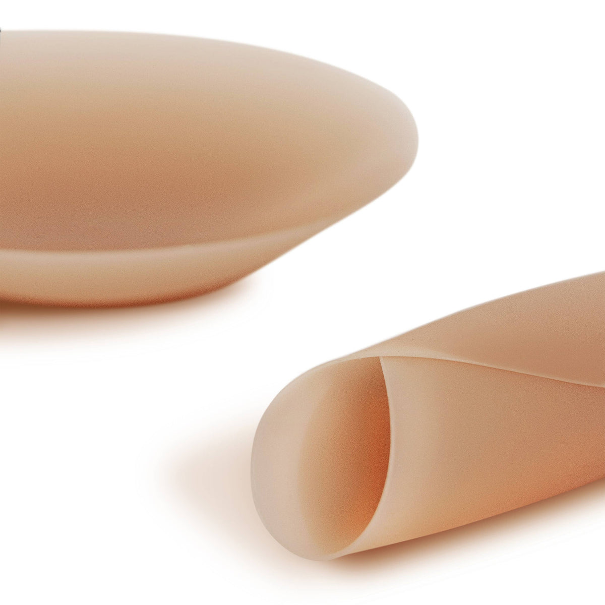 Two beige silicone sheets on a white background