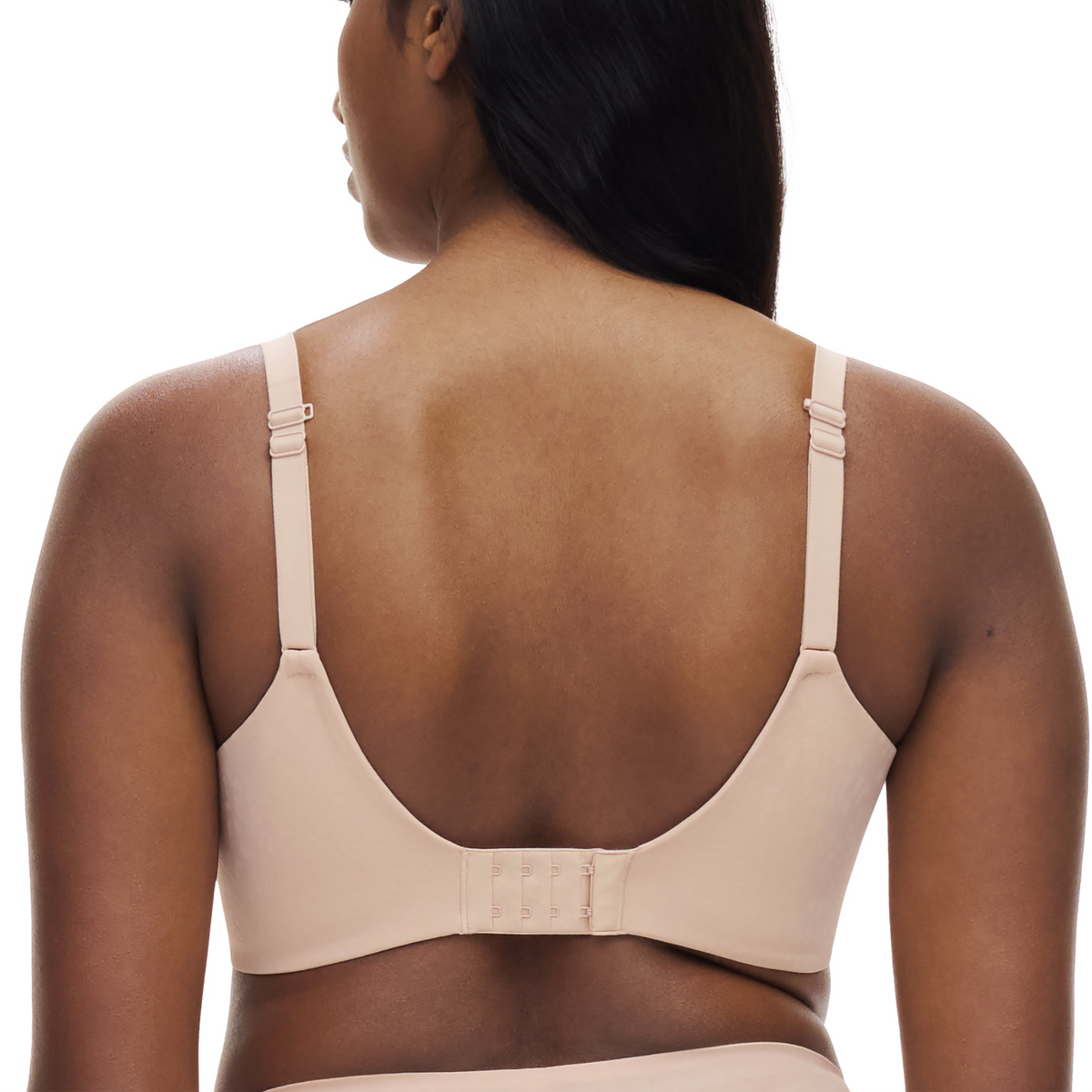 Beige bra worn by a person on a white background