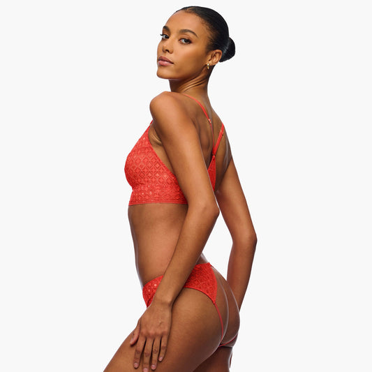 Woman wearing a red bikini against a white background