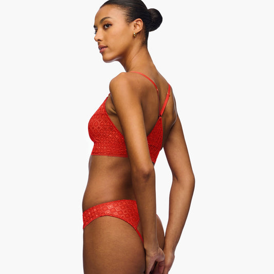 Woman wearing a red bikini on a white background
