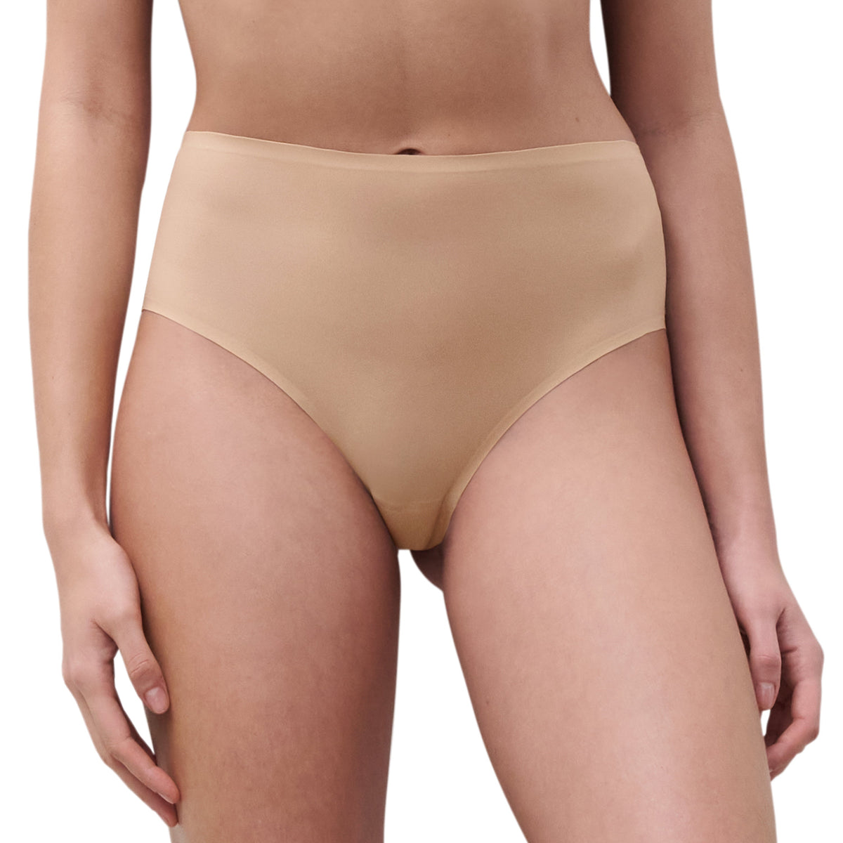 A high-cut beige thong underwear with seamless leg openings and coverage at the back.