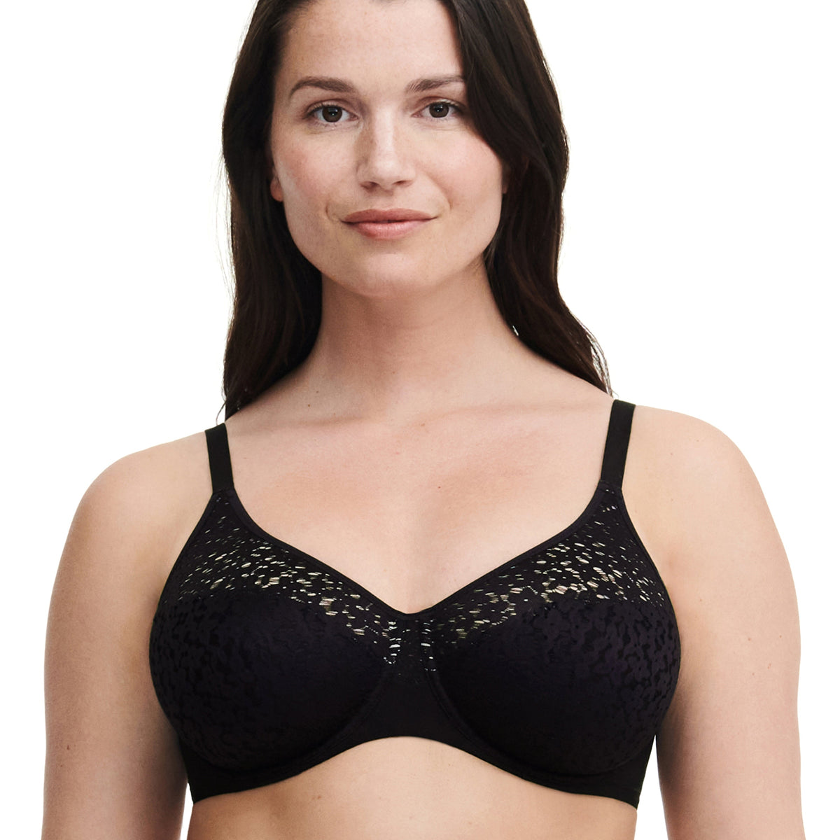 A woman wearing a black underwire bra with floral details.