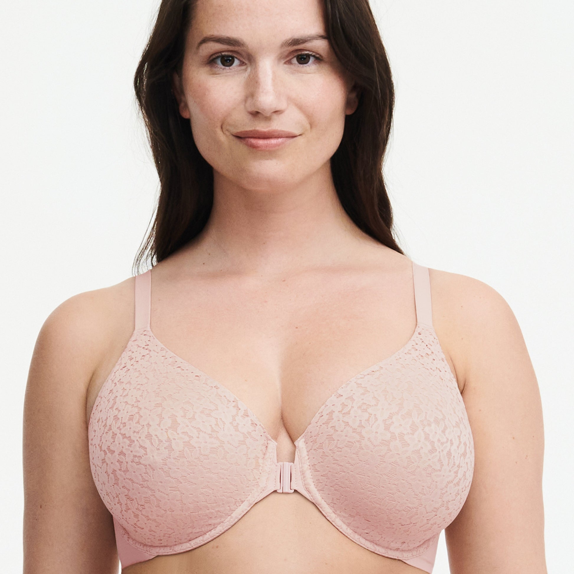 A front view of a woman wearing a pink front closure bra with floral details.