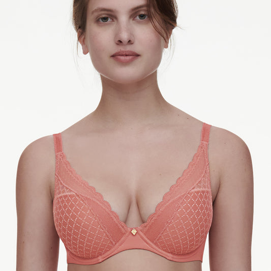 A woman wearing a pink t-shirt bra with lace detailing.