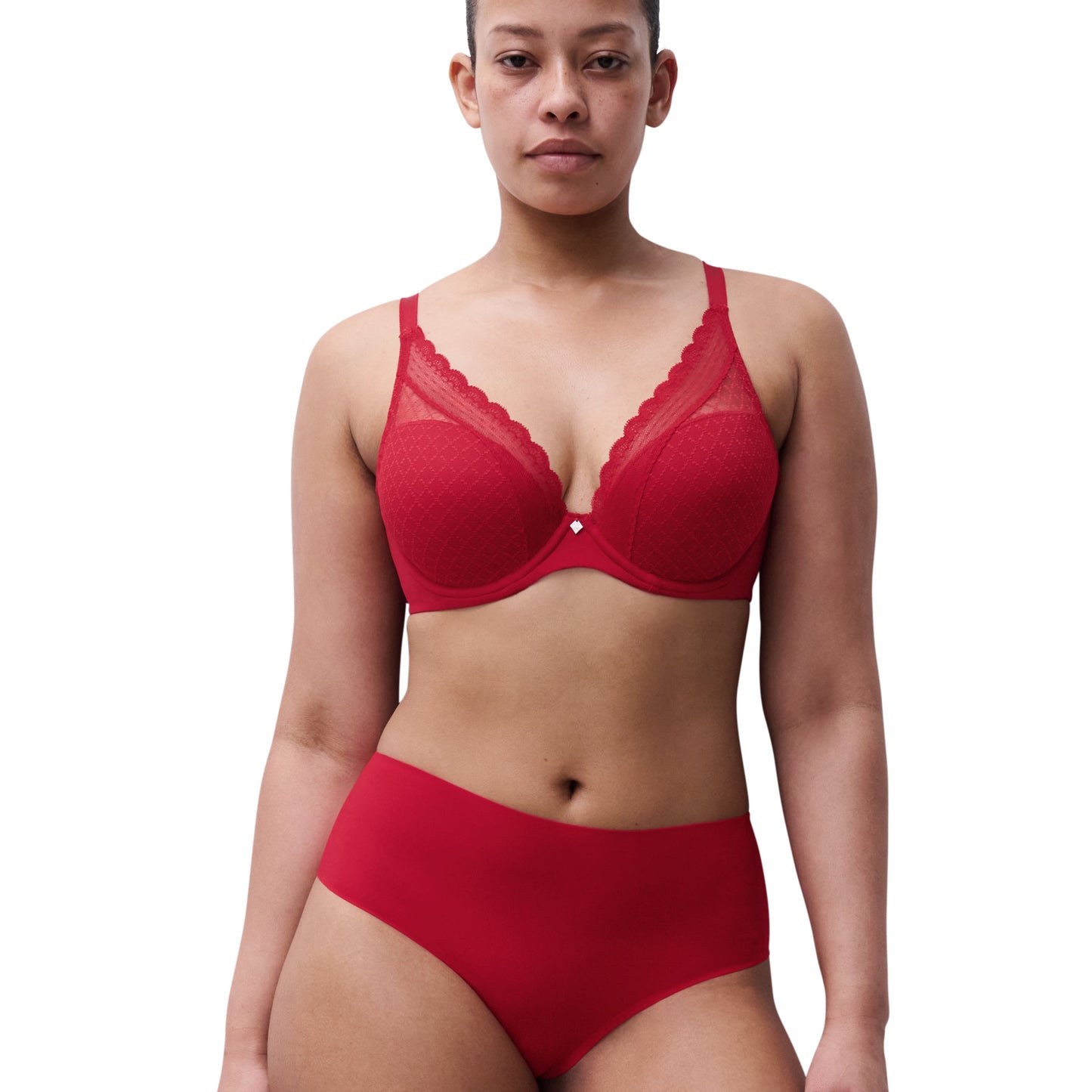 Woman wearing a red bra and panties set on a white background