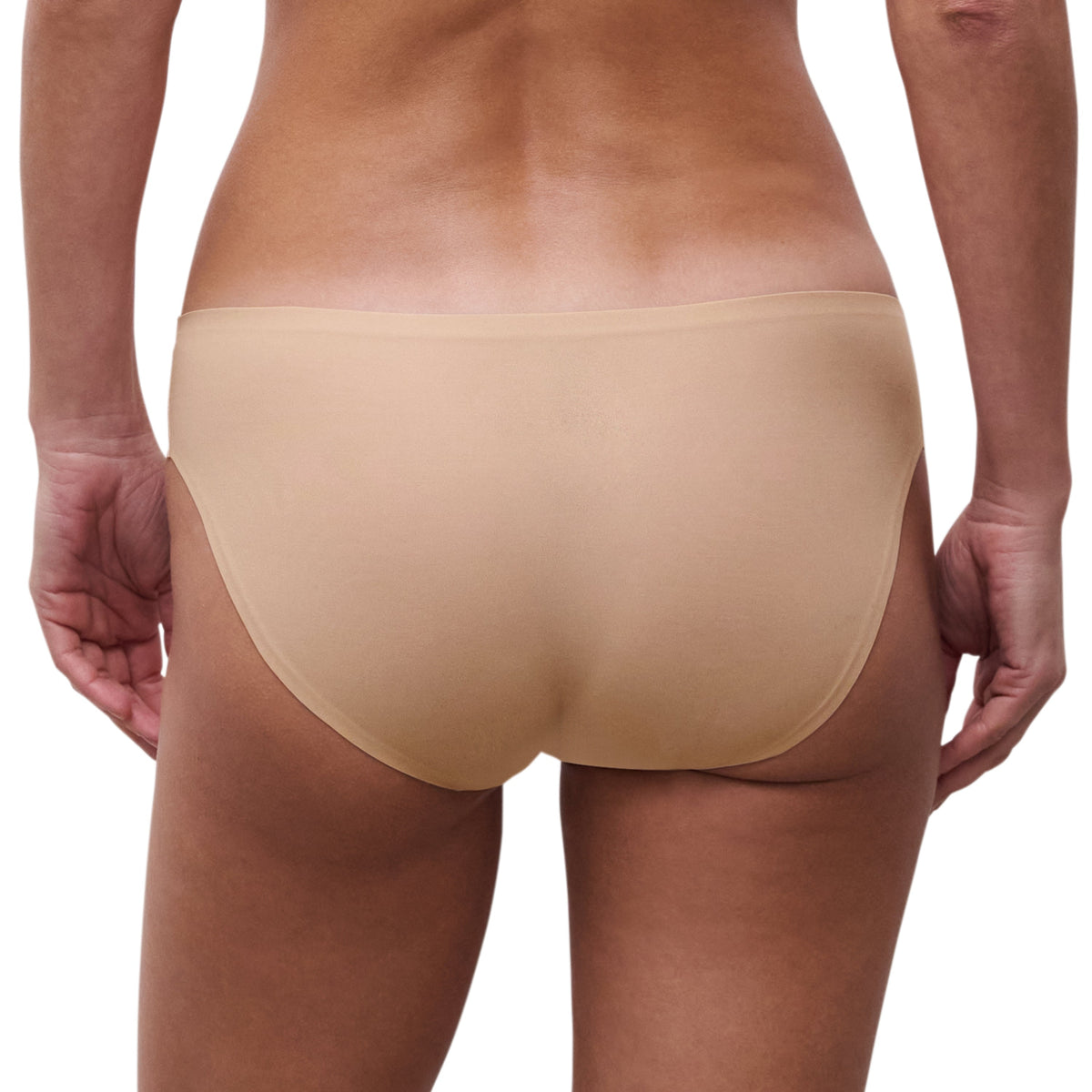 Beige underwear worn by a person on a white background