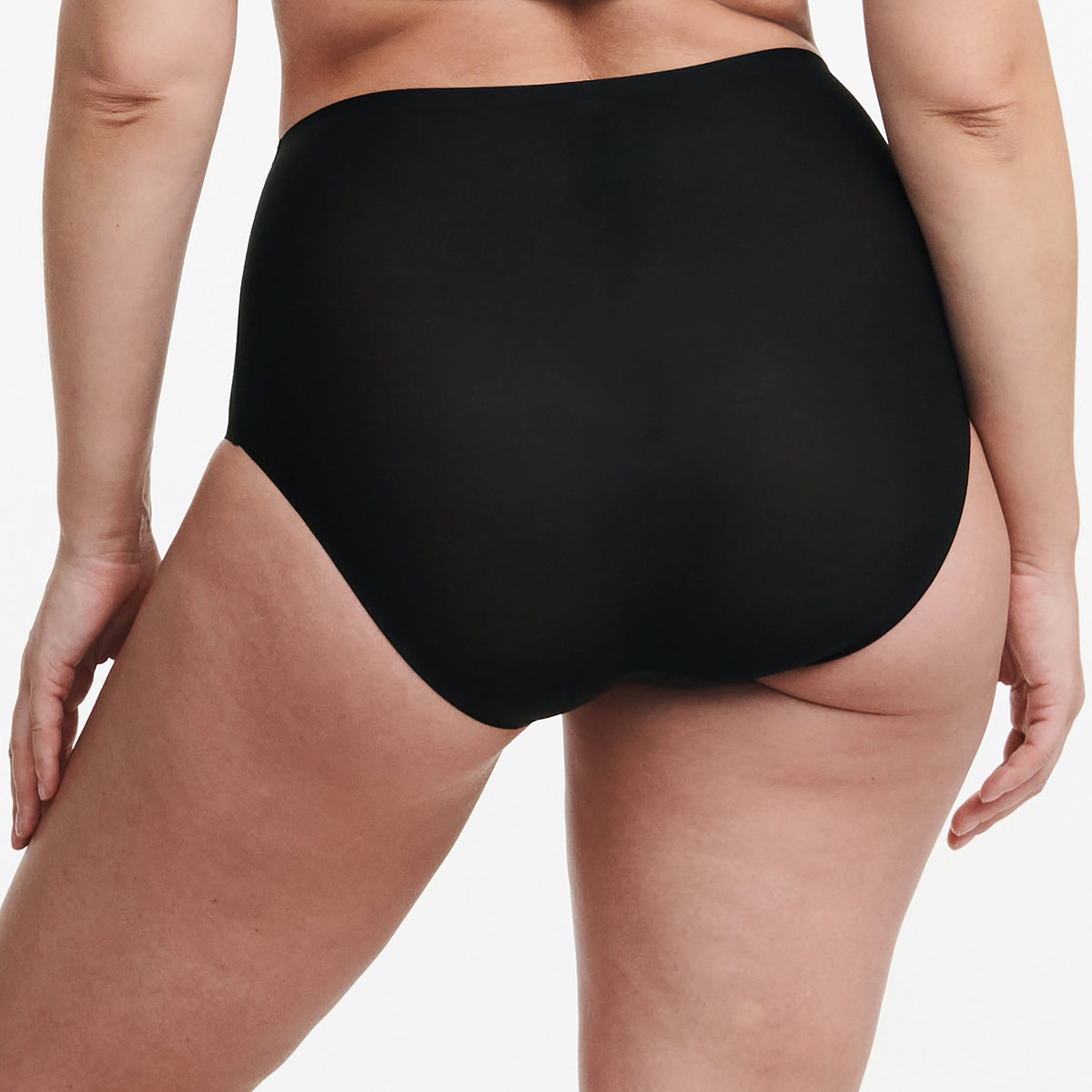 Black high-waisted underwear worn by a person on a white background