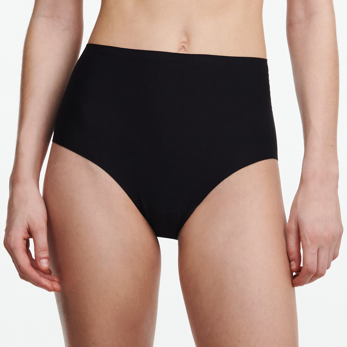 Person wearing black high-waisted underwear on a white background