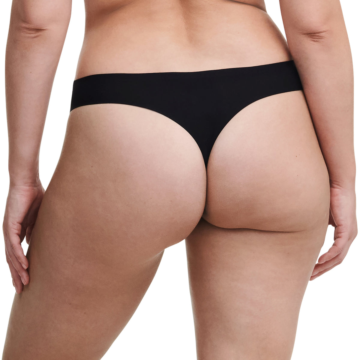 Black thong worn by a person on a white background