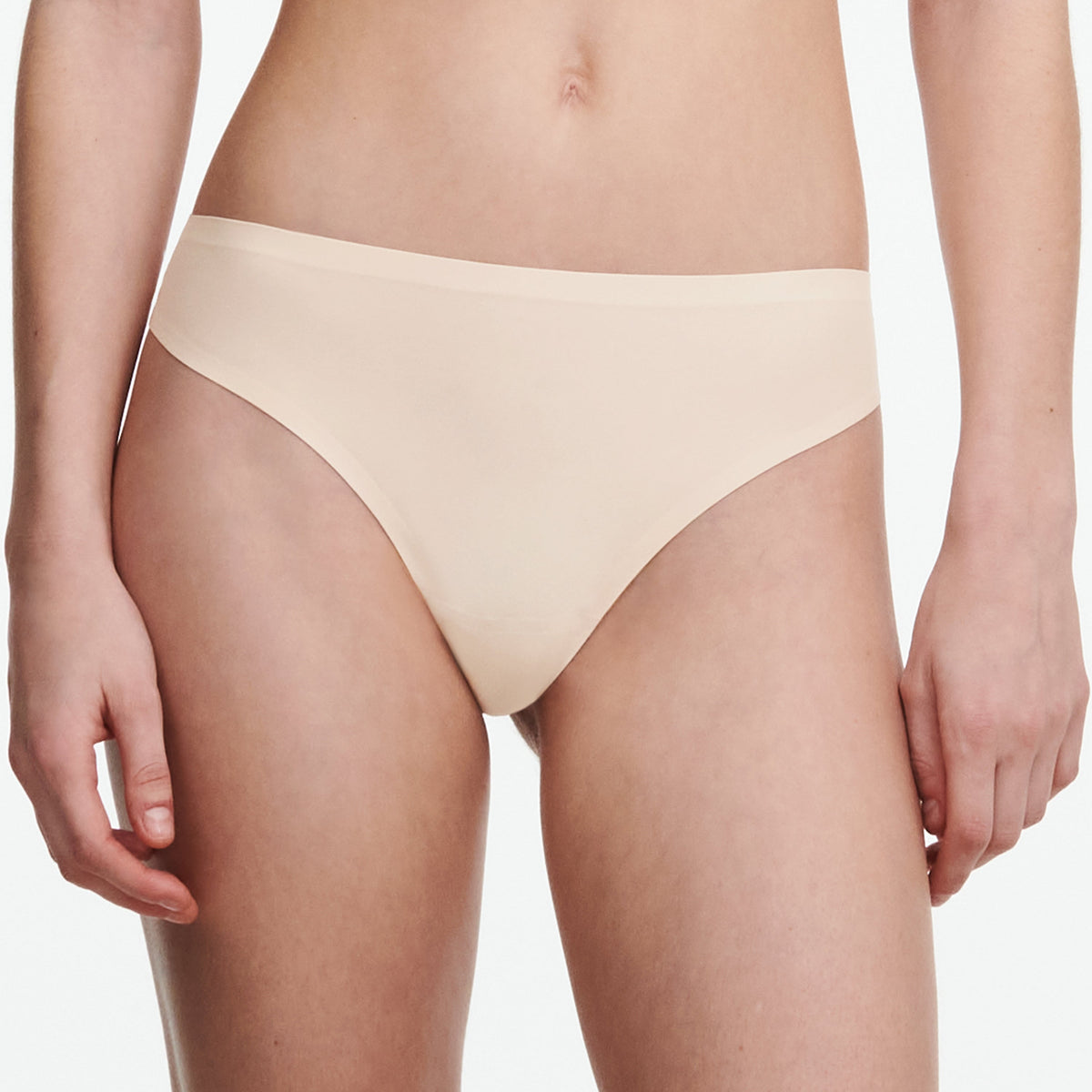 A seamless beige thong underwear on a model.