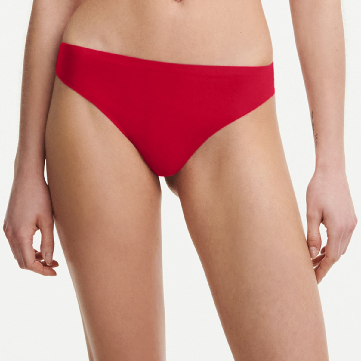 Red bikini bottom worn by a person on a plain background