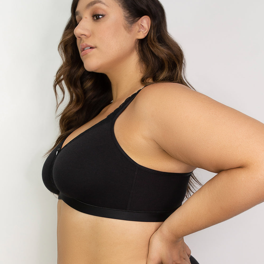 Woman wearing a black sports bra against a plain background