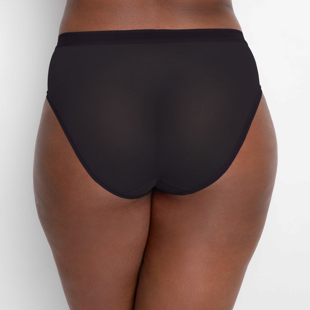 Black high-waisted underwear worn by a person on a white background