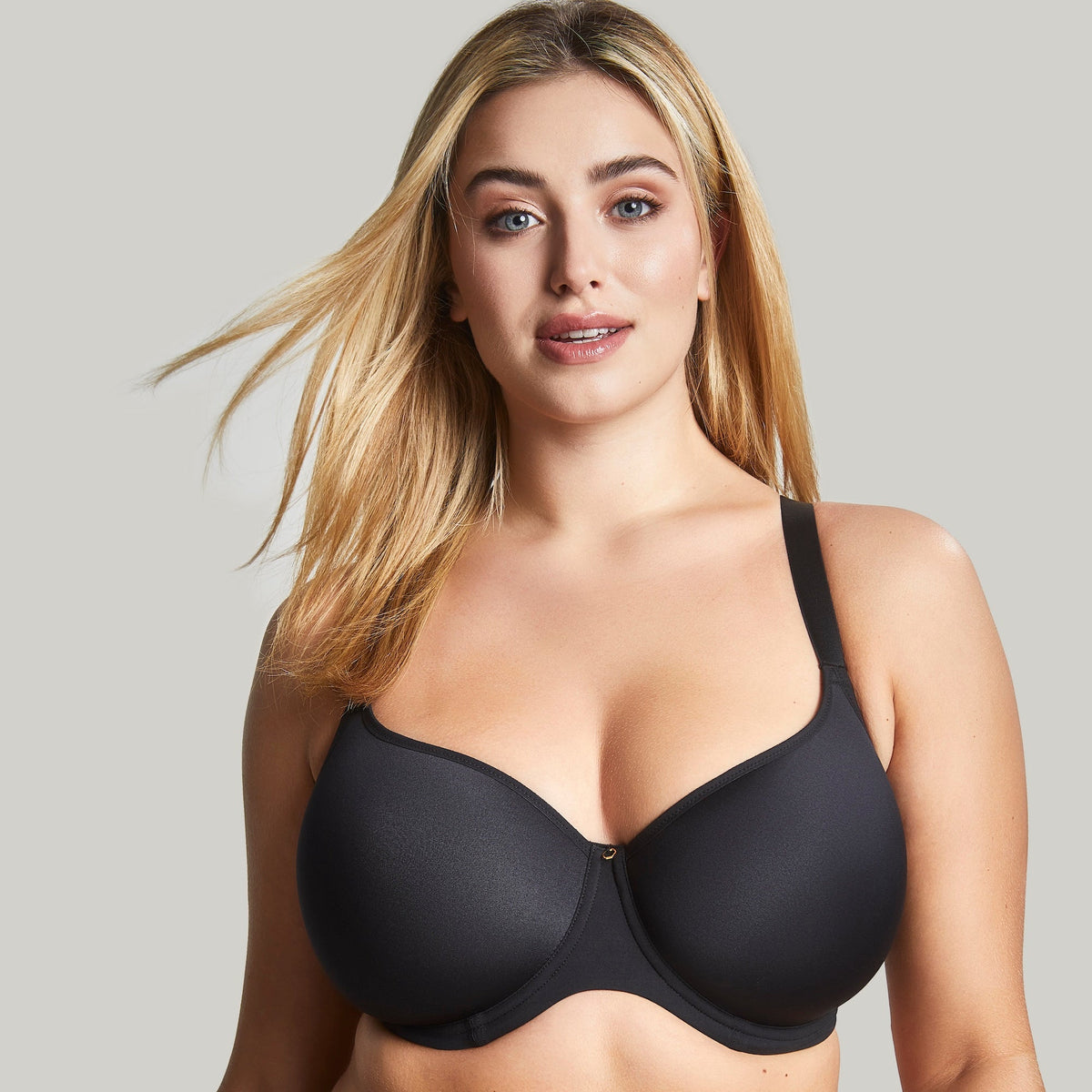 A woman wearing a black moulded spacer t-shirt bra with adjustable straps.