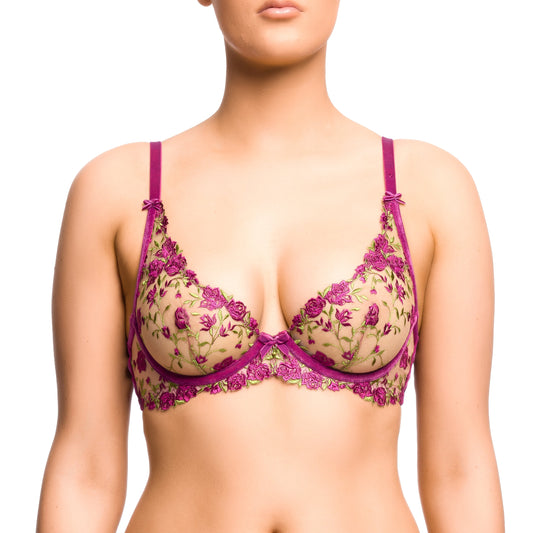 Woman wearing a floral lingerie set with a purple trim on a white background