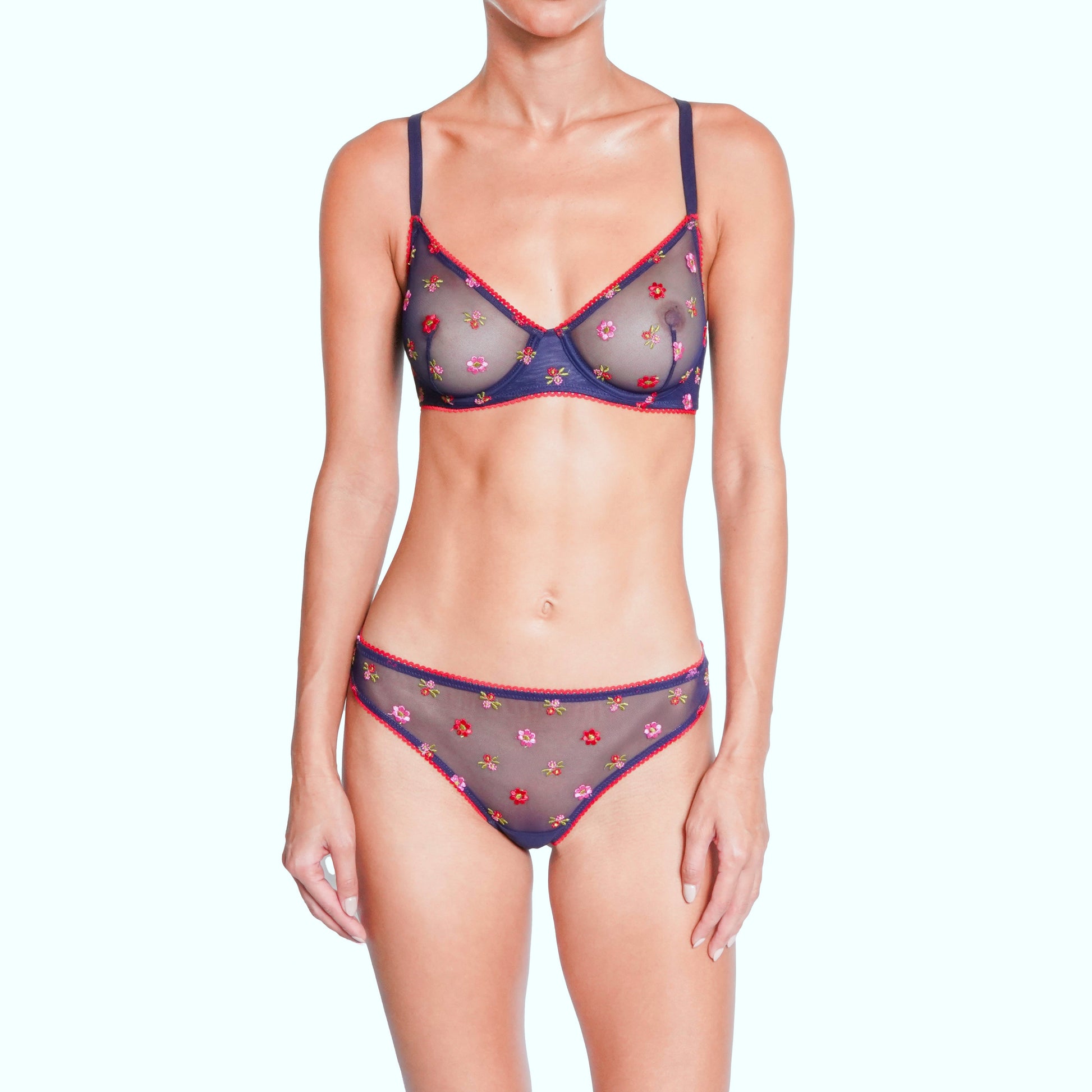Woman wearing a patterned lingerie set on a white background