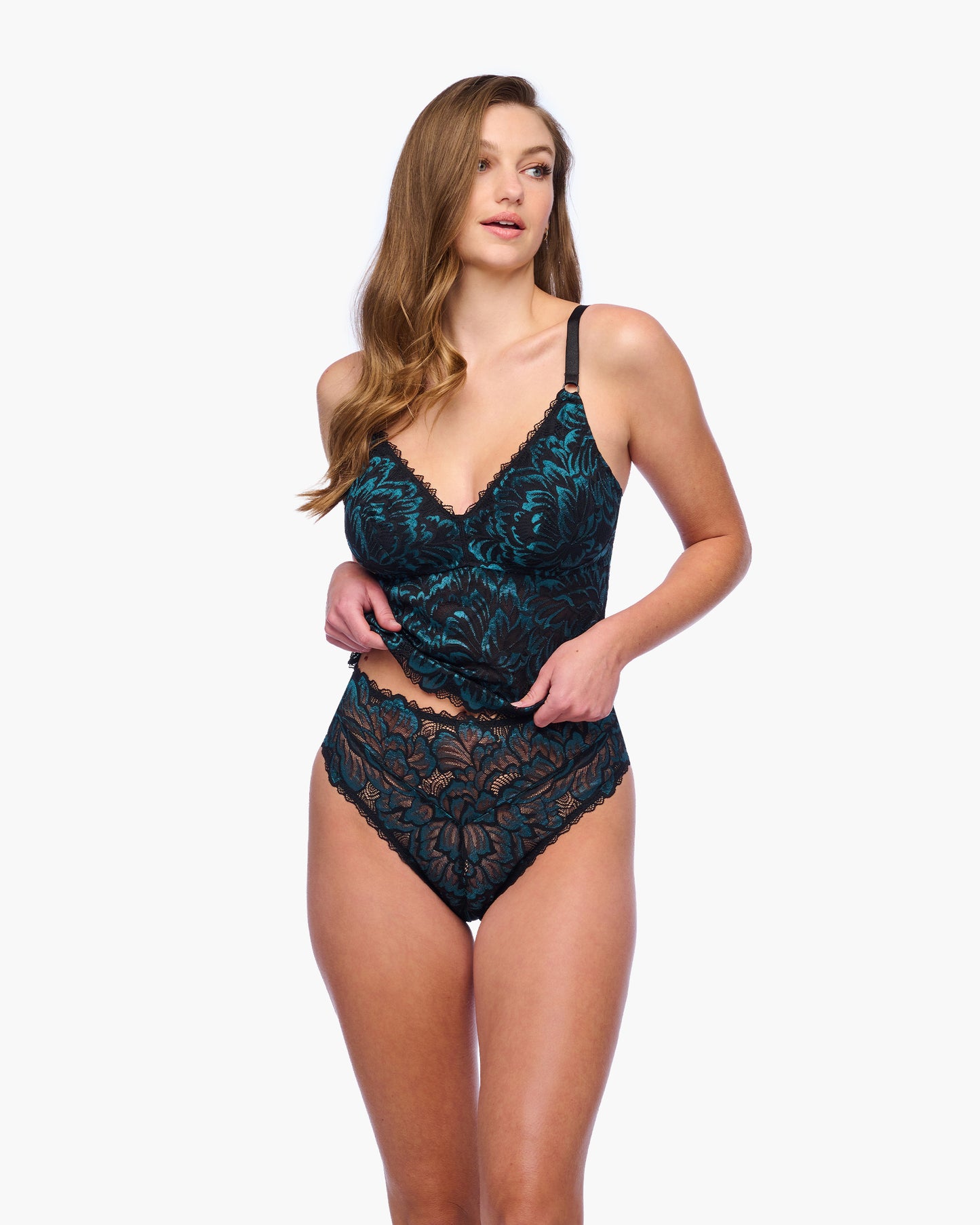 Woman wearing a black lace lingerie set on a white background