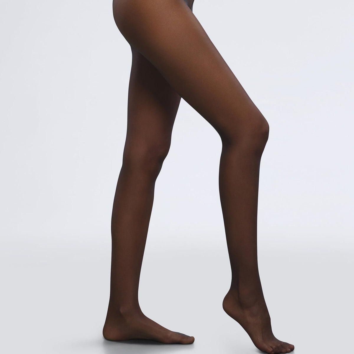 Black tights worn by a person on a white background