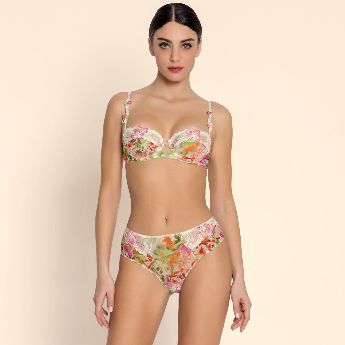 Woman wearing a floral bikini set on a beige background