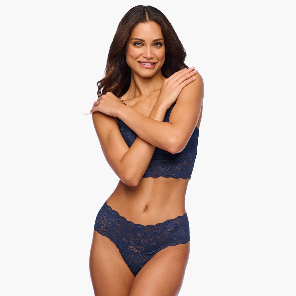 Woman wearing a navy blue lace lingerie set on a white background