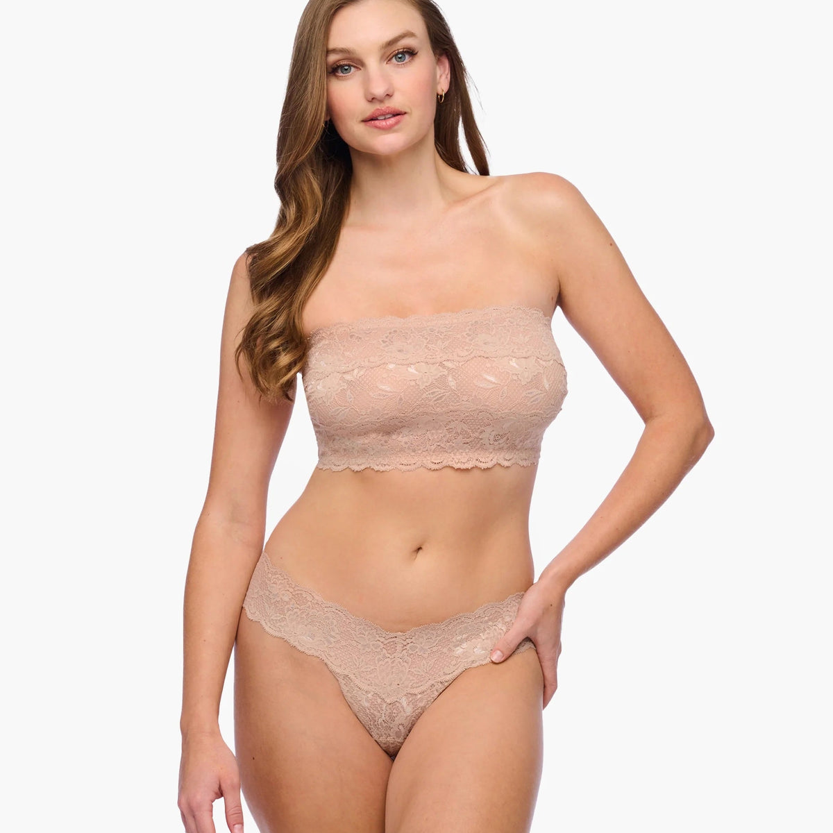 Woman wearing a beige strapless top and panties set on a white background