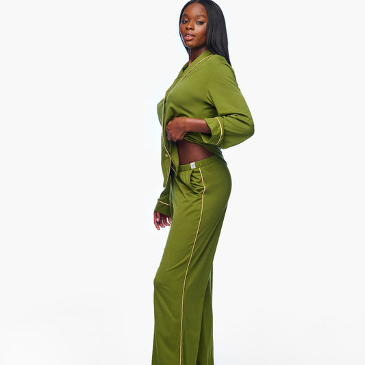 Woman wearing a green outfit on a white background