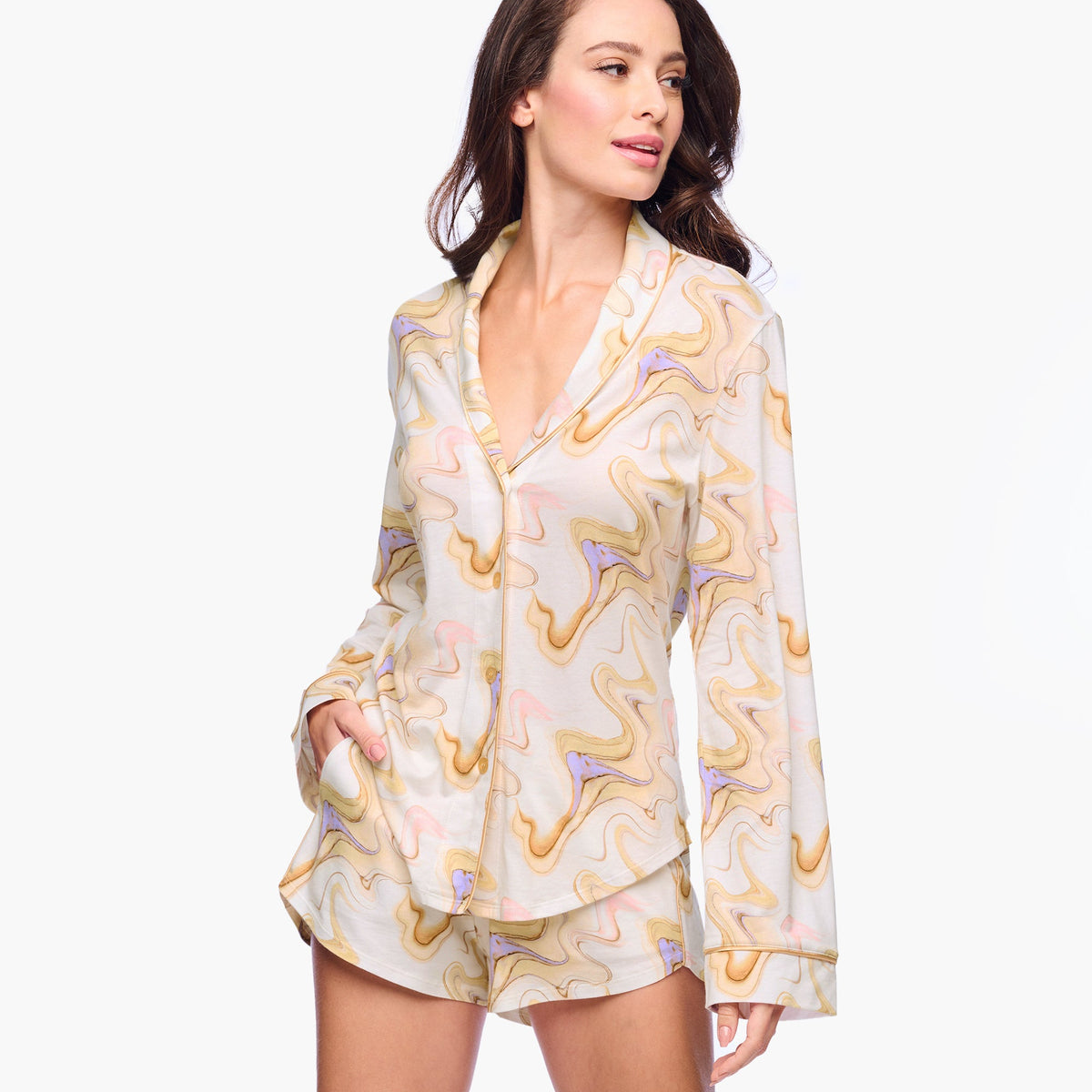 Woman wearing a patterned pajama set on a white background