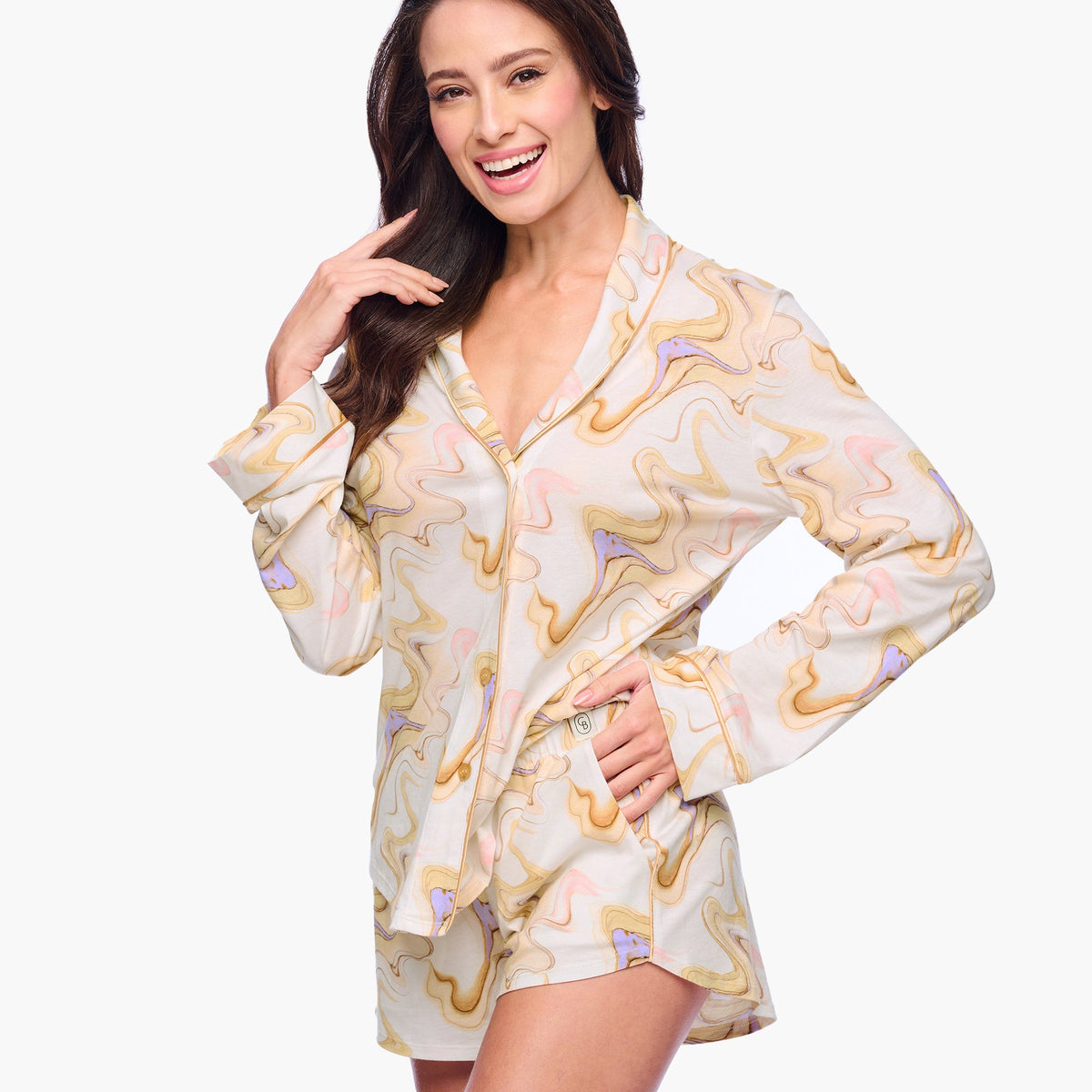 Woman wearing a patterned pajama set on a white background