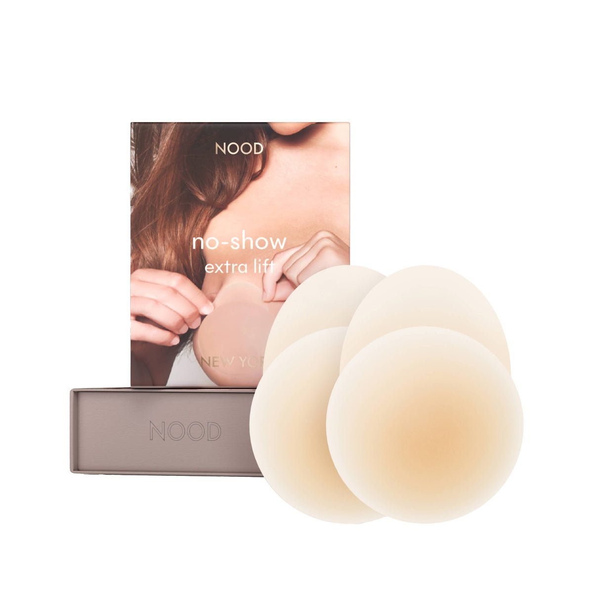 Three beige silicone breast lift pads shown in front of their packaging box, which features a model demonstrating the application on the chest.