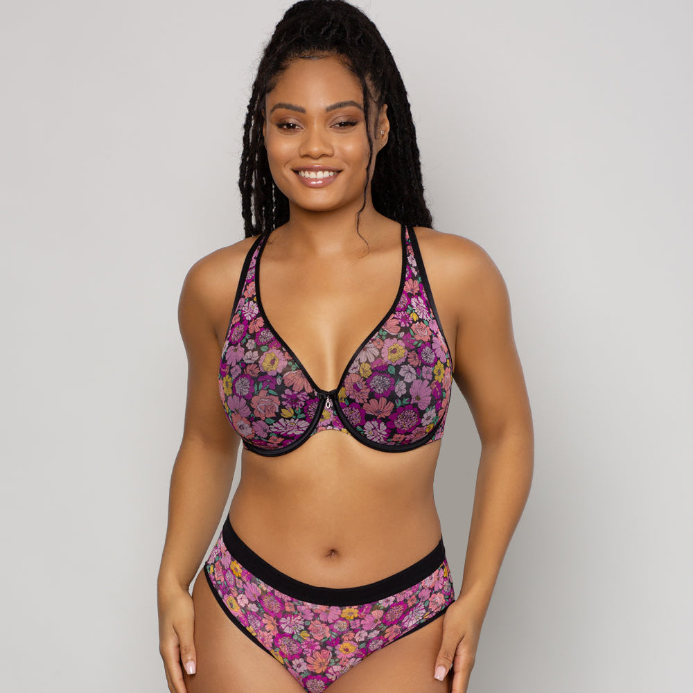 Woman wearing a floral bikini set on a plain background