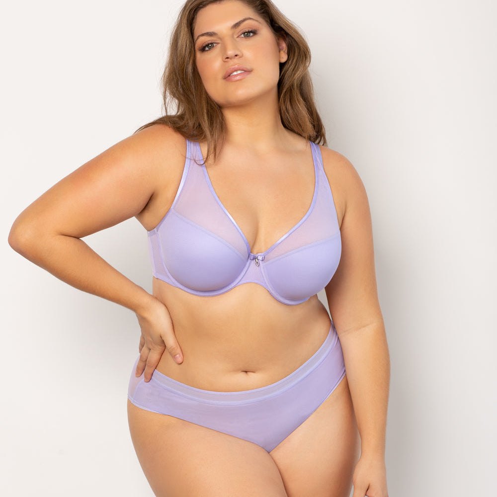 Woman wearing a lavender bikini set against a plain background
