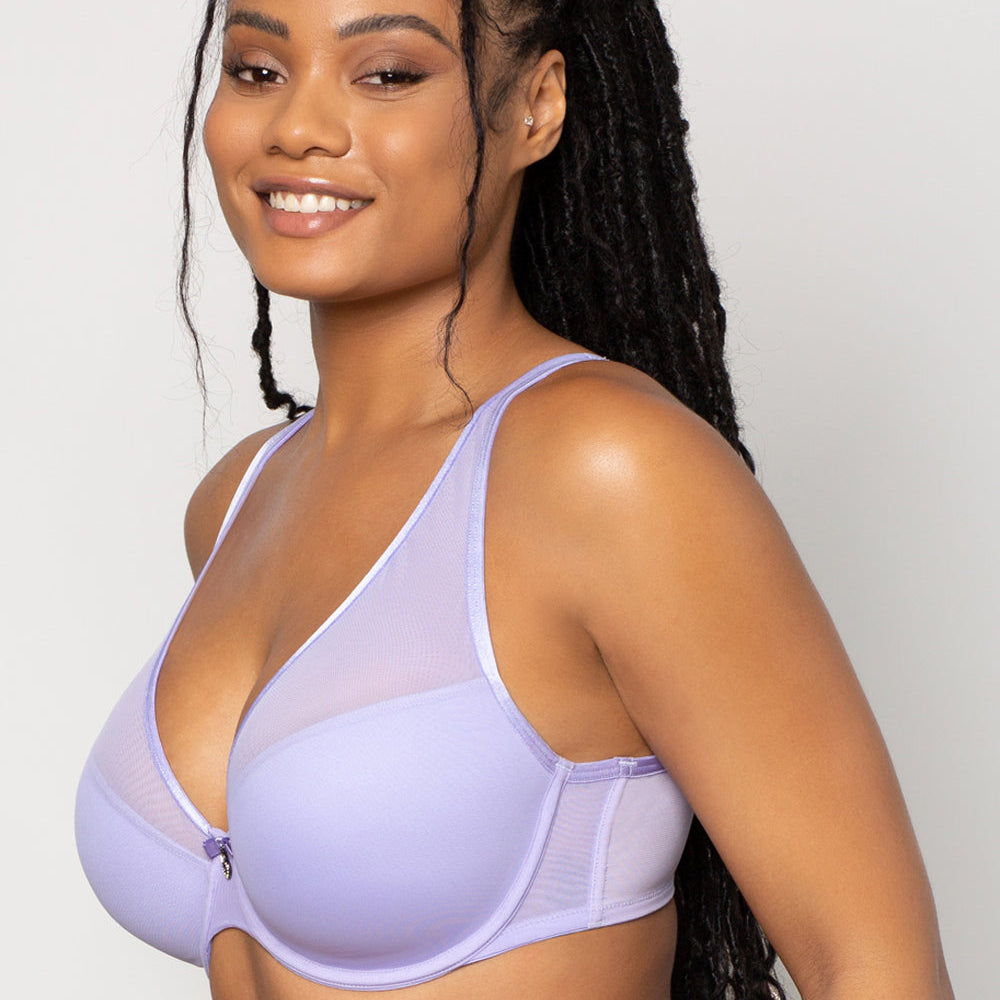Woman wearing a light purple bra against a plain background
