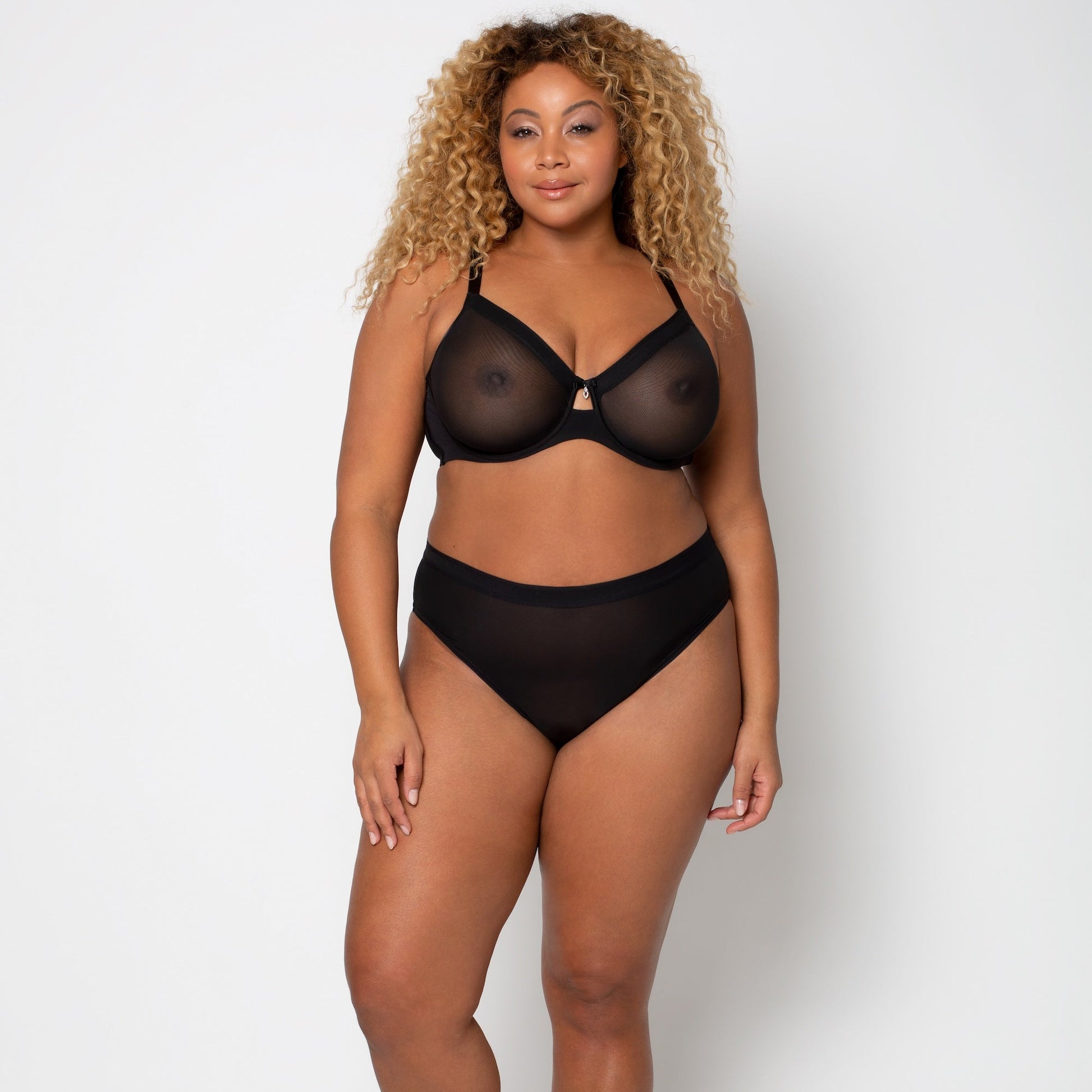 Woman wearing a black lingerie set on a white background