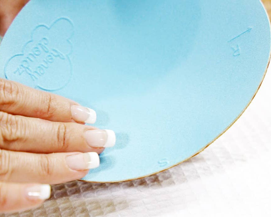 Hand holding a blue circular object with 'Honey Cloudz' branding.