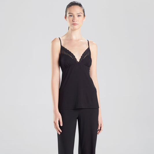 Woman wearing a black lace camisole and wide-leg pants on a white background