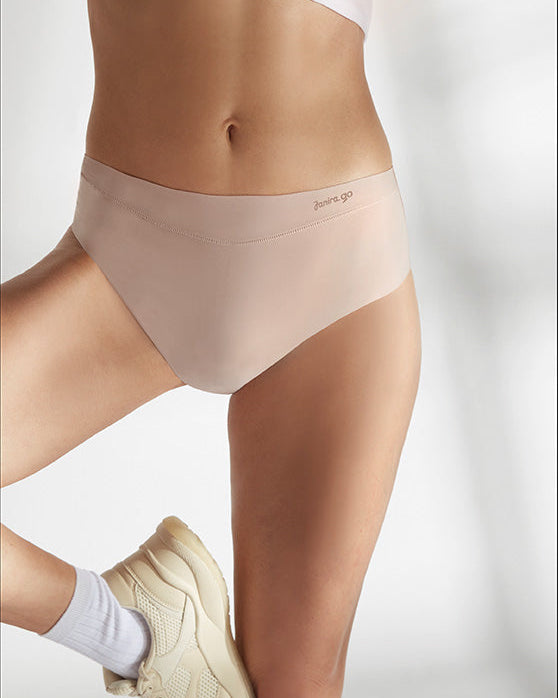 Person wearing beige underwear with a white background