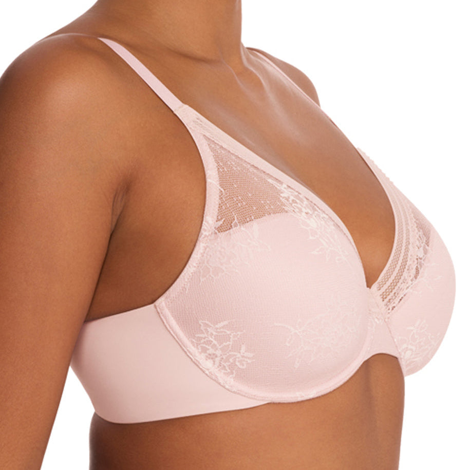 Woman wearing a light pink bra and underwear set on a white background