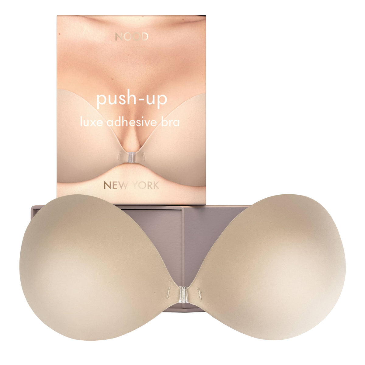 Beige push-up adhesive bra with packaging on a white background